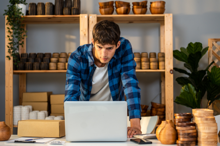 Caucasian businessman checking how to find product market fit for vase goods order for customer on laptop